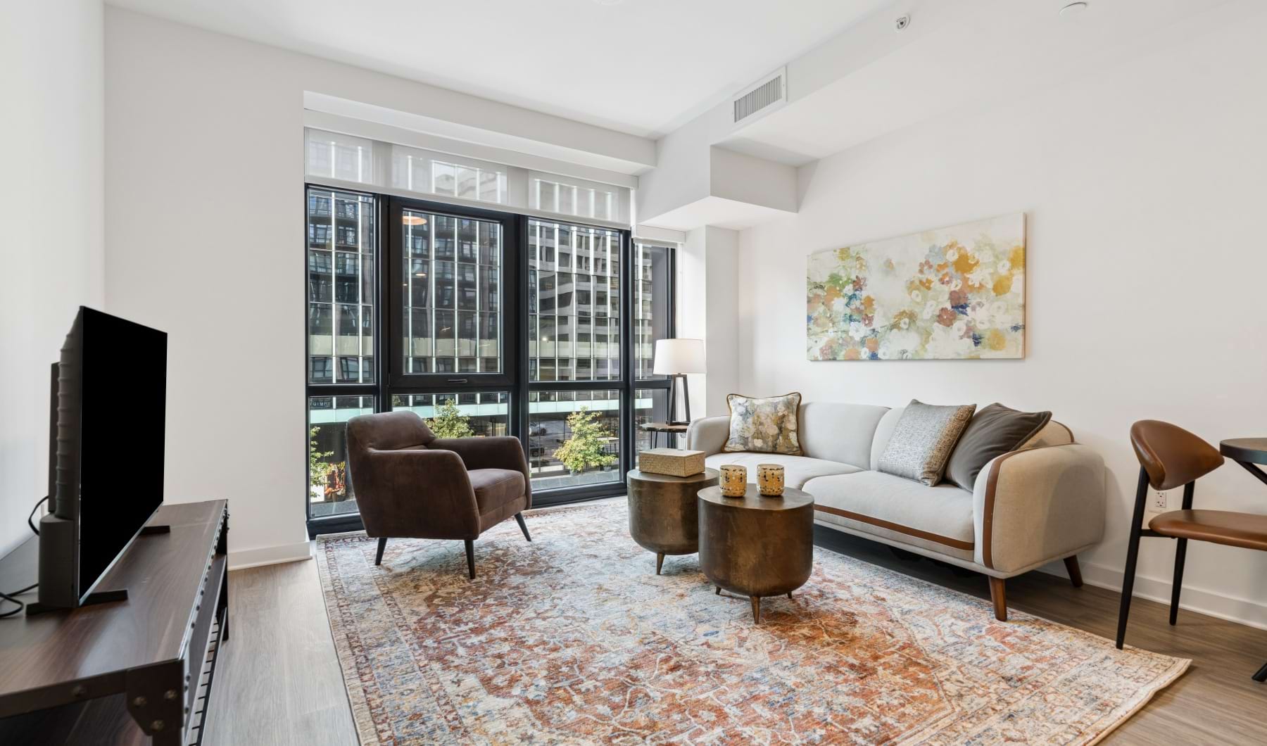 Sun-filled living room featuring floor-to-ceiling windows