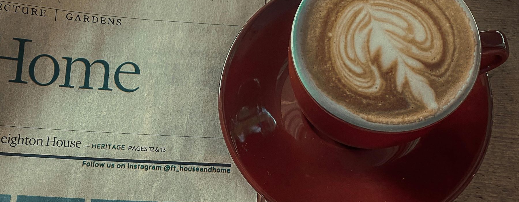 a cup of coffee on a newspaper